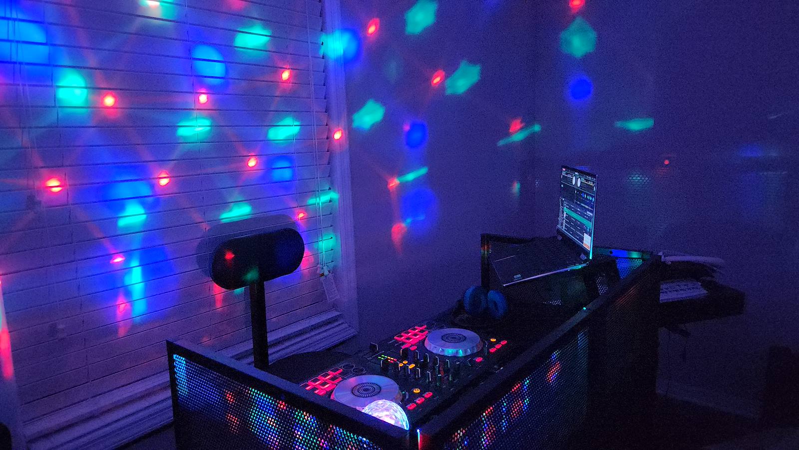 DJ booth illuminated with colorful party lights