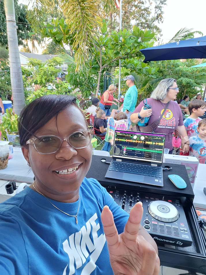 DJ Maina B smiling at a community event