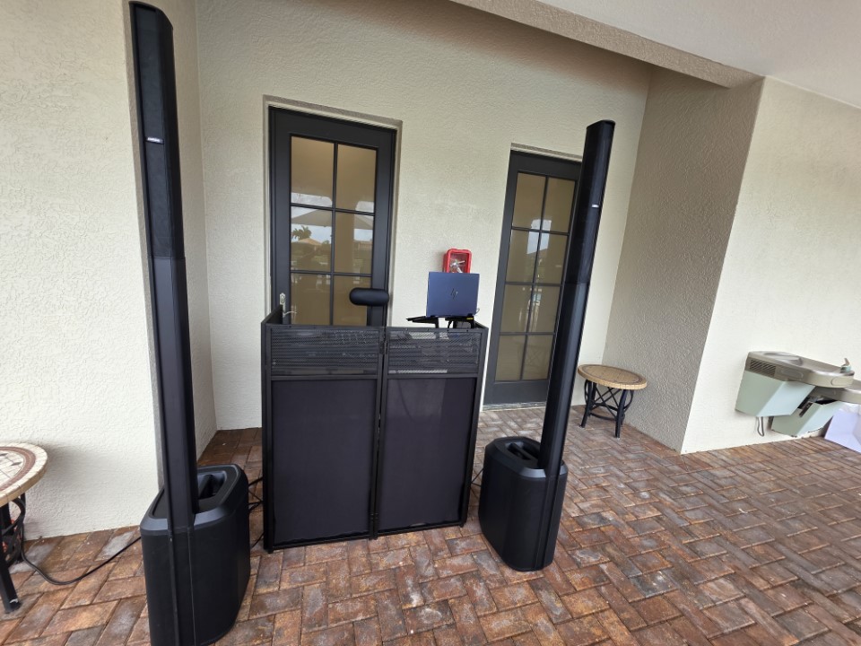 DJ booth with a pair of Bose speakers